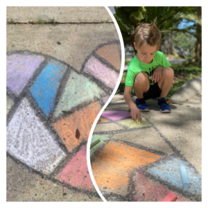 A child draws a heart with chalk
