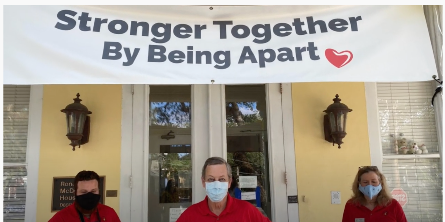 RMHC-SLA staff stand in front of Strong Together sign